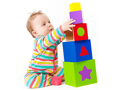 Picture of a baby playing with coloured blocks