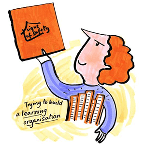 Graphic showing a person holding a book