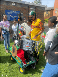 A group of people standing around a drum set