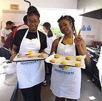 A group of people holding plates of food