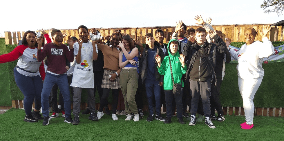 A group of people standing on a grass field