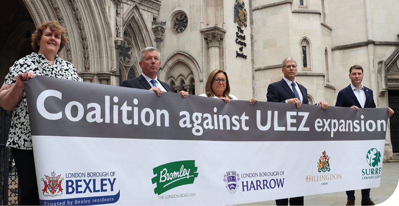 group of people holding sign coalition against ULEZ expansion