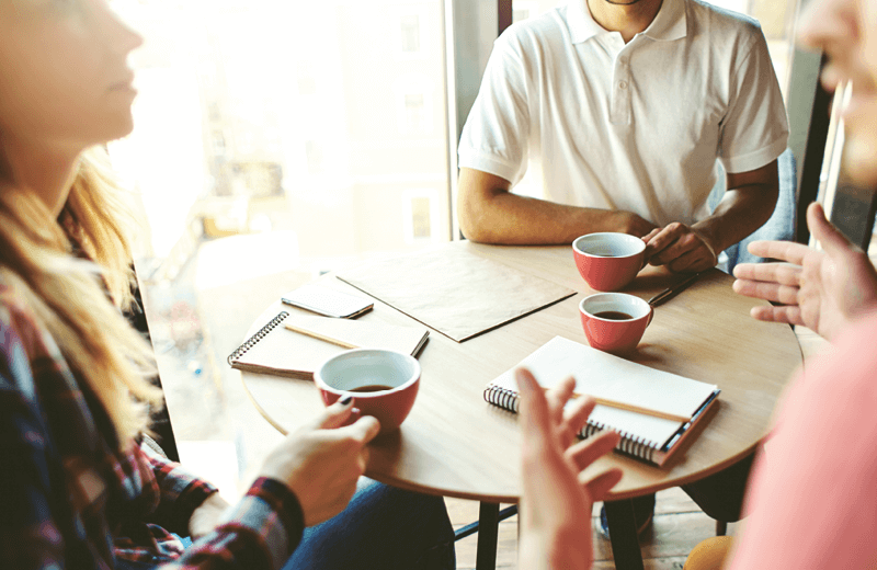 A group of people sitting round a table