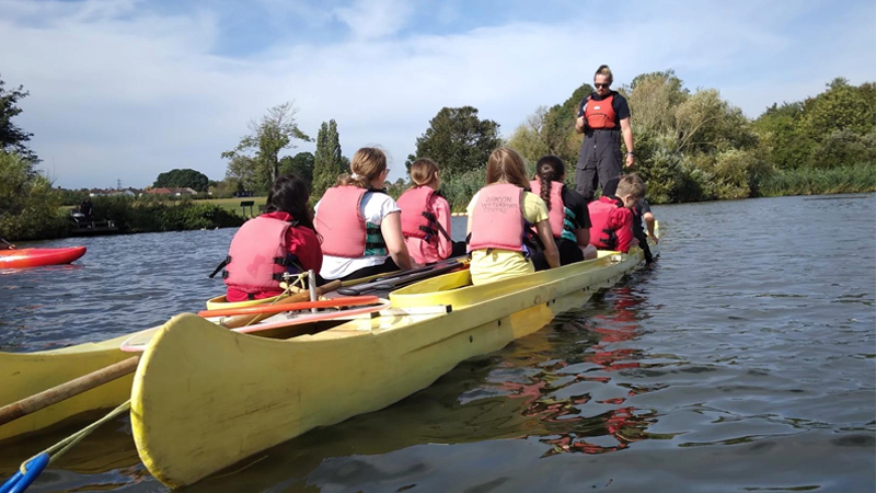 Image of someone teaching canoeing to young people at Danson Park