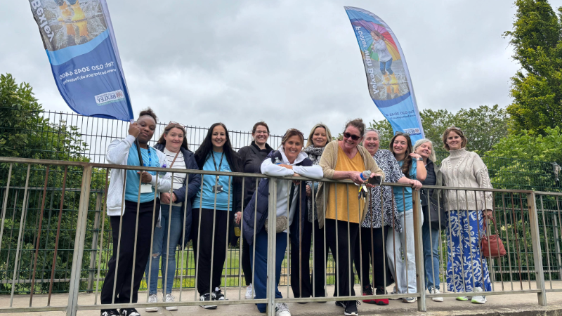 Bexley's Fostering team holding a flag on a bridge