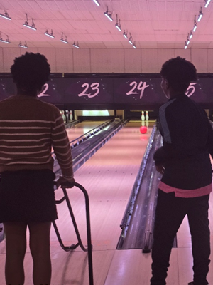 Kids playing bowling at a bowling lane