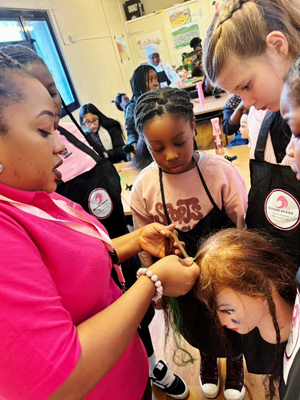 Kids taking part in hair braiding and styling lesson