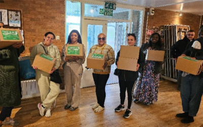 People holding HAF food boxes