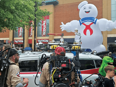 Photo of movie characters and a child at the Super Saturday event