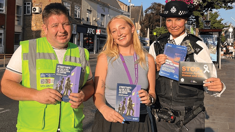 Image of volunteers working with police on the community safety event