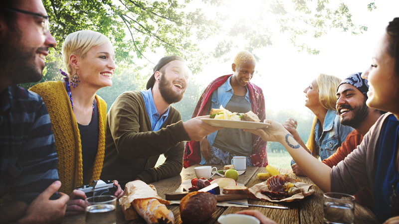 Image shows lots of people eating outside