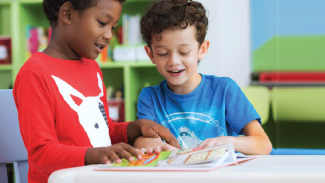Children reading a book together