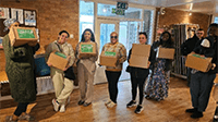 A group of people holding boxes