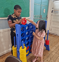 A child and child playing with a game