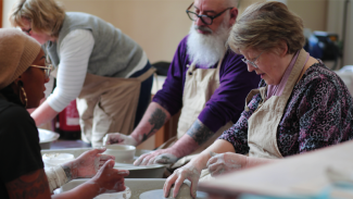 Decorative image of people making pottery