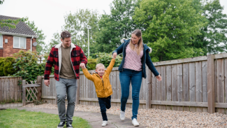 Image of a family of three walking and having fun