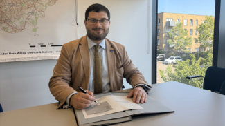 Image of leader of the council signing a form 