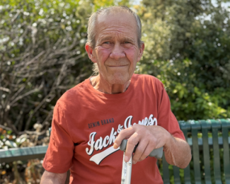 Image of a gentlemen sitting on a bench