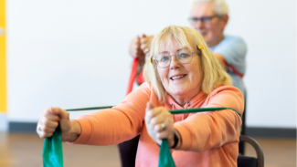 old resident with glasses exercising in a community space