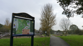 Pathway in the Dell Park and sign with a map.