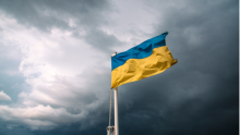 The flag of Ukraine flying against a stormy sky