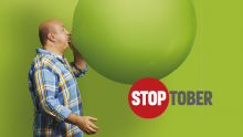 Image of a man blowing up a balloon as part of the Stoptober stop smoking campaign