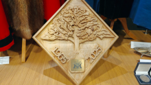 Image of the intricately carved wooden plaque including the 'Charter Oak'