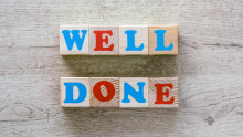 Image of alphabet blocks spelling out 'well done'