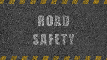 Tarmac road with words Road Safety painted on it